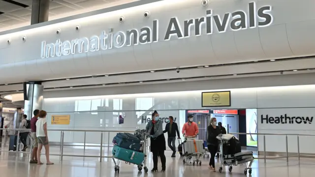 Passengers wearing PPE arrive at Heathrow in May