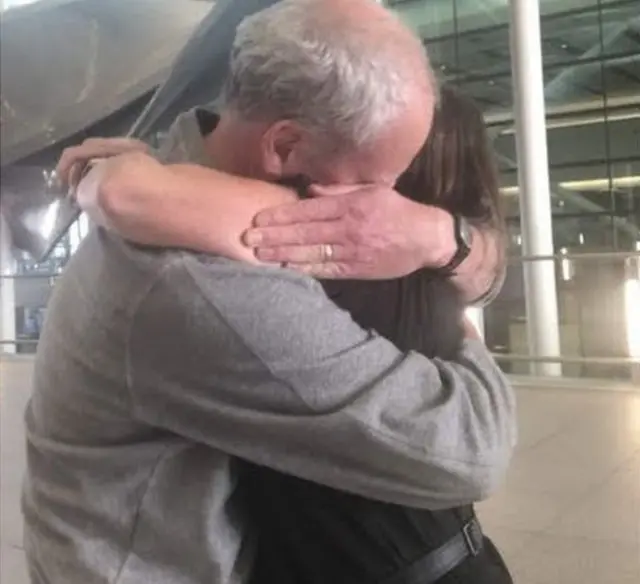 Jeanette Hall hugs her husband