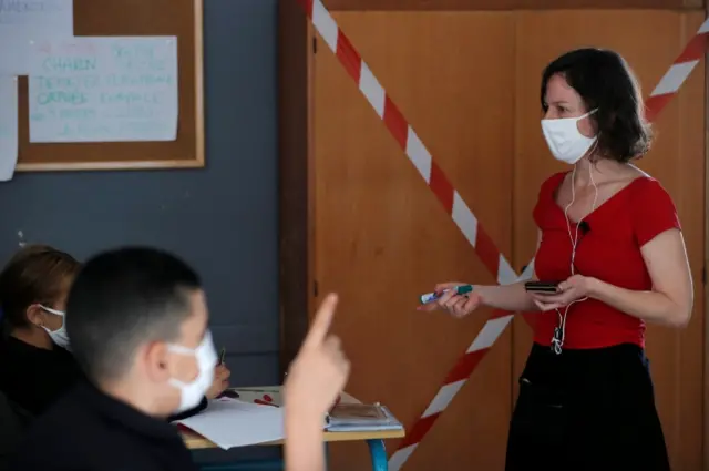 French teacher Morgane Legrand wears a protective face mask