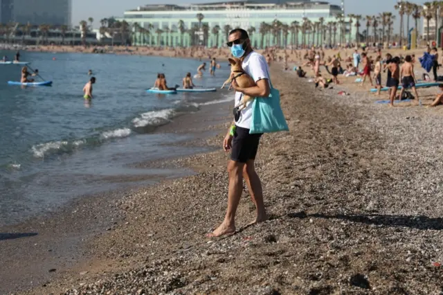 A Spaniard on the beach with his dog in Barcelona