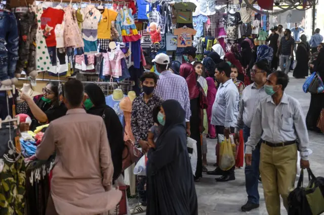 People shop at a market ahead of the Muslim Eid al-Fitr festival in Karachi on May 20, 2020.