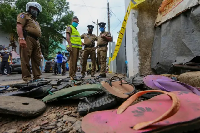 Police officers at the scene of a crush in Sri Lanka which killed three people