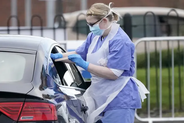 A woman testing a person in a car