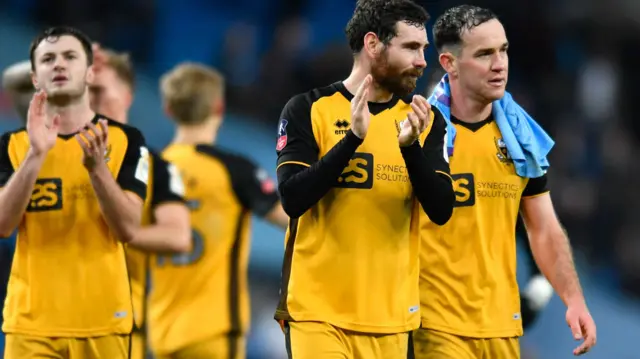 Port Vale players applaud the fans