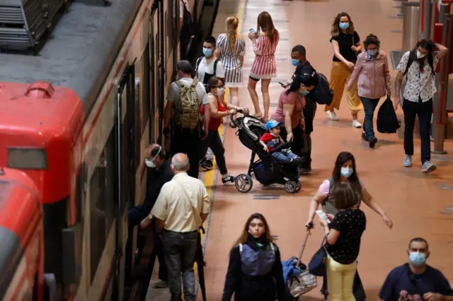 Passengers at a train station in Madrid