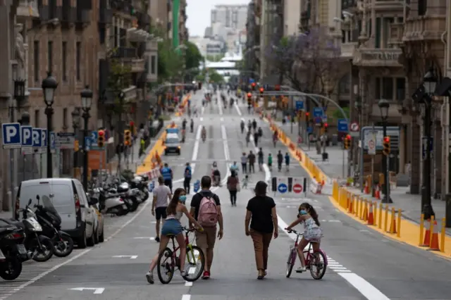 People walk on a road turned into a pedestrian street in Barcelona