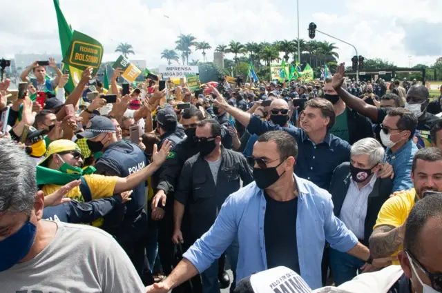 Bolsonaro waving to a crowd of supporters on Sunday