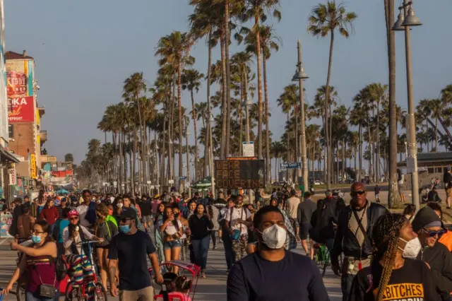 People on the boardwalk in Venice Beach during the first day of the Memorial Day holiday weekend amid the novel Coronavirus, COVID-19, pandemic in California on 23 May, 2020.