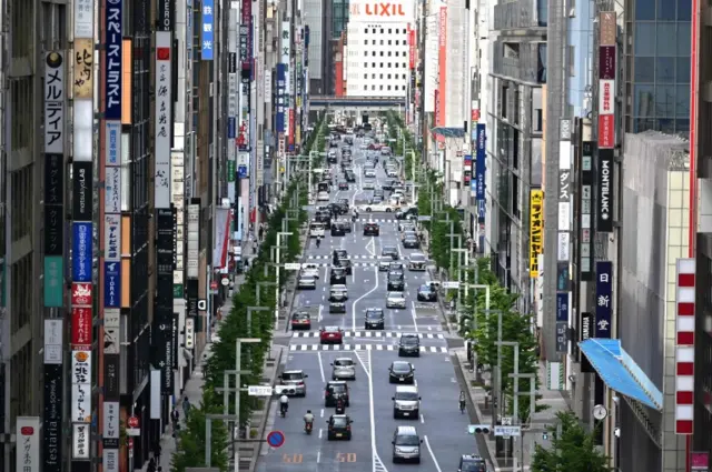 Motorists make their way through Ginza avenue in Tokyo on 25 May