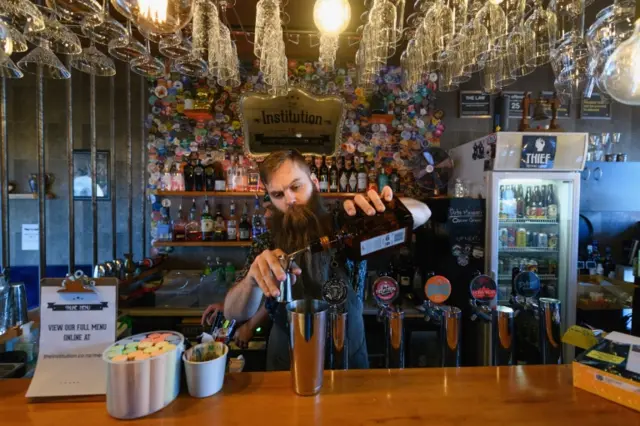 A barman mixes a cocktail in Christchurch, New Zealand