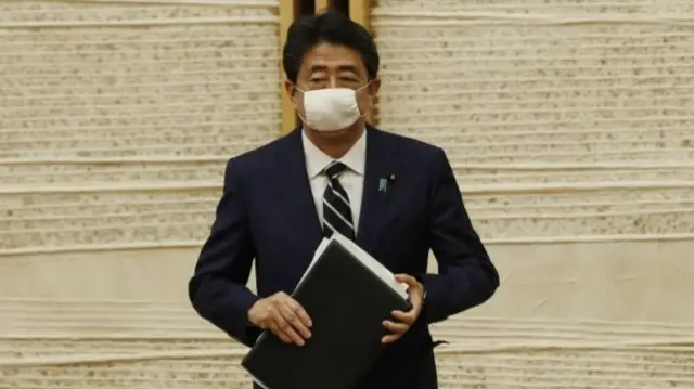 Prime Minister Shinzo Abe leaves after a news conference in Tokyo