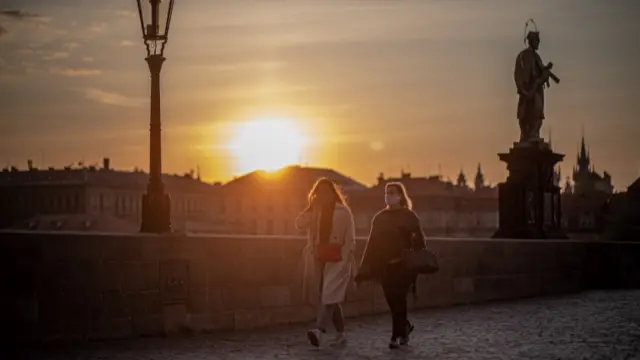 Women with face masks on Charles Bridge in Prague