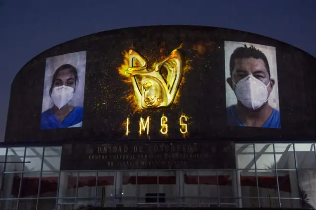 Lights and photos are projected onto the Mexican Institute of Social Security (IMSS) building in Mexico City on May 25