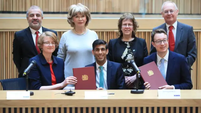 Councillors Shabir Pandor, Denise Jeffery, Judith Blake and Tim Swift, (front row, left to right) Susan Hinchcliffe, Chancellor Rishi Sunak and Simon Clarke MP after the signing of the West Yorkshire Combined Authority devolution,