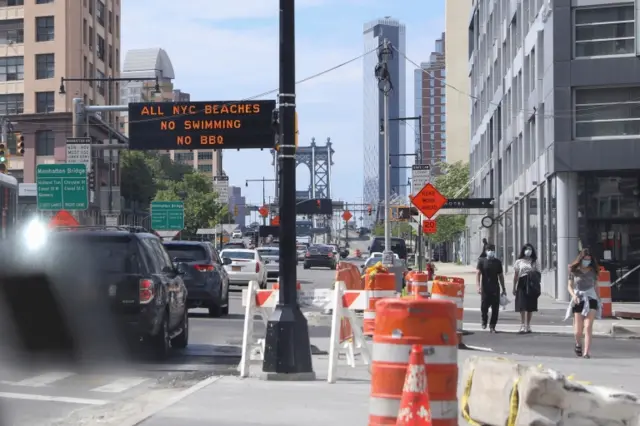 A sign advising New York City residents of precautionary rules is seen on Memorial Day