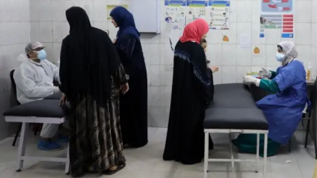 Medical personnel speak with patients at a Cairo hospital during the coronavirus pandemic