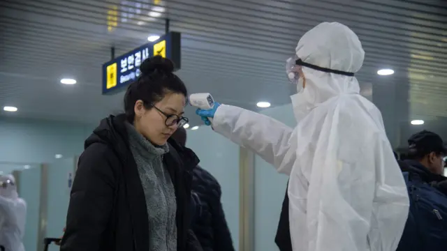 Foreign diplomats and embassy staff have their temperatures recorded prior to boarding flight