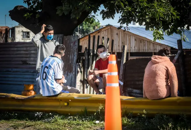 Youths in masks near cones