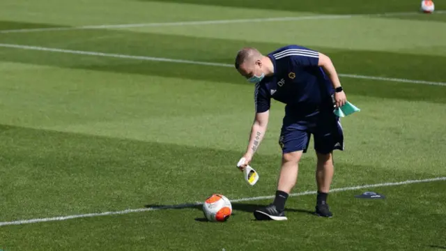 A ball is sprayed with disinfectant during a training session at Wolves