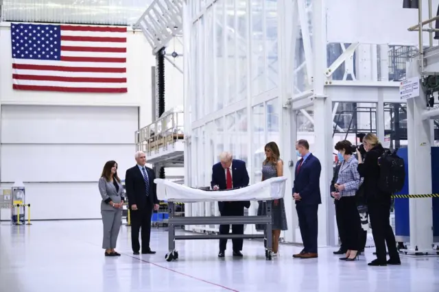 Trump signs an object at Kennedy Space Center