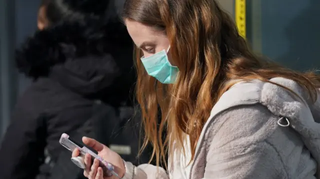 A young woman wearing a face mask