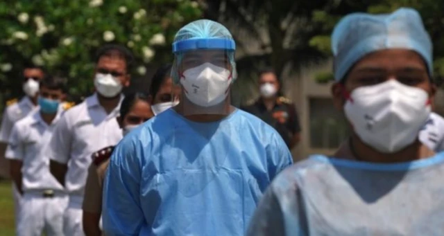 Health care workers in Mumbai wearing face masks, shields and hazmat suits