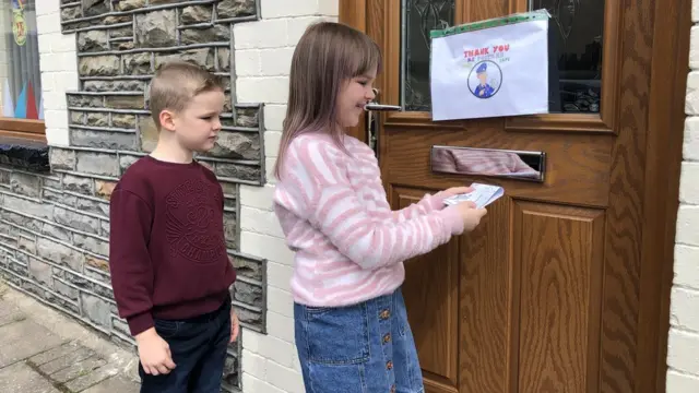 Children posting newsletter