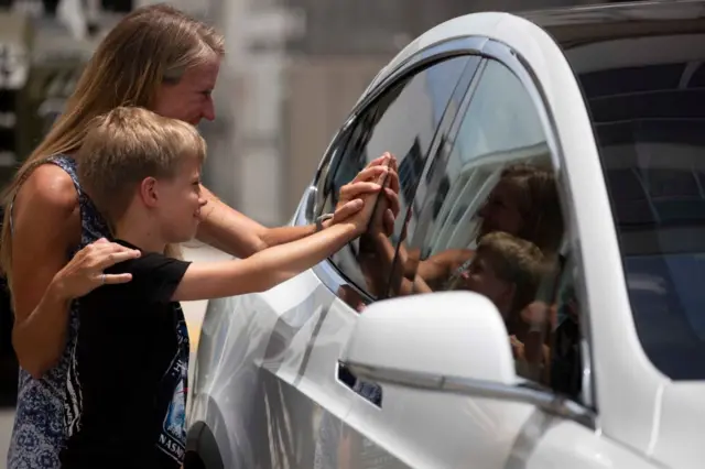 Karen Nyberg and son share a moment with husband Astronaut Doug Hurley before he boards to the SpaceX Falcon 9