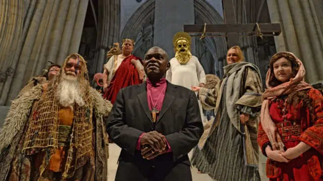 The Archbishop of York, Dr John Sentamu (centre), with cast and crew members, ahead of the opening night of the York Minster Mystery Plays