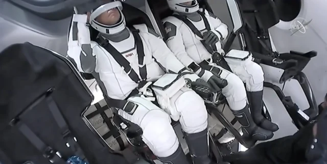 Astronauts inside capsule