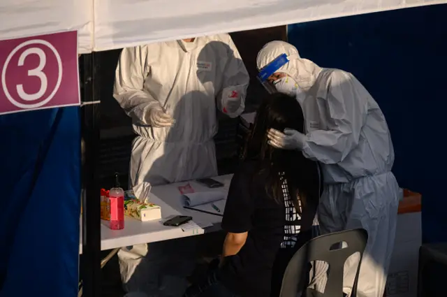 A health worker administers a swab at a temporary COVID-19 novel coronavirus testing centre in Bucheon, South Korea