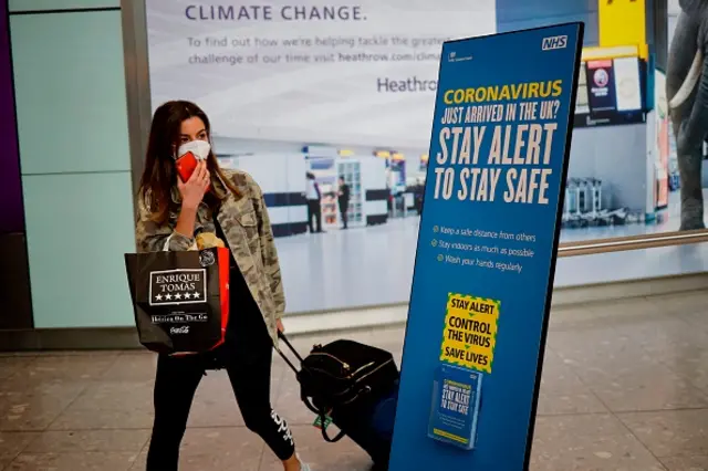 A woman arrives at Heathrow