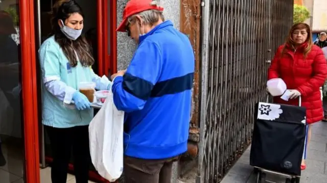 A free food collection point in Madrid to ease hardship