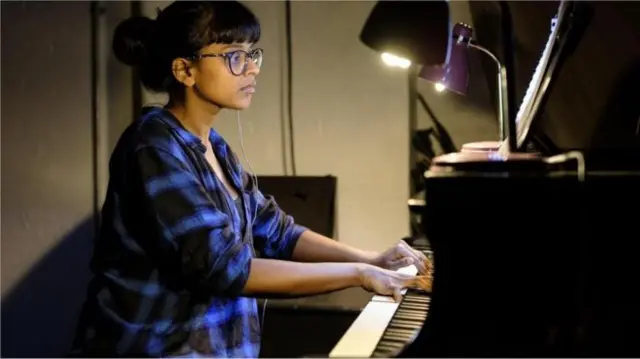 Yshani Perinpanayagam at a piano