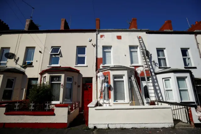 A painter at work on a house