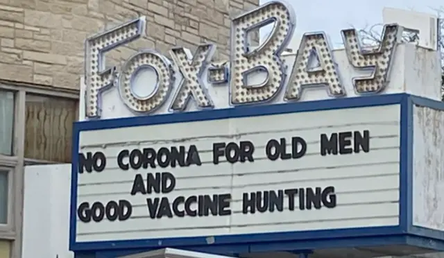 Cinema sign in the US, with a coronavirus-inspired message saying: 'Good vaccine hunting'