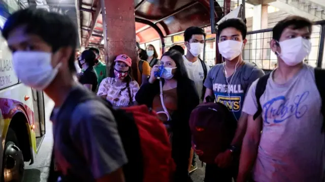 People with face masks in Manila