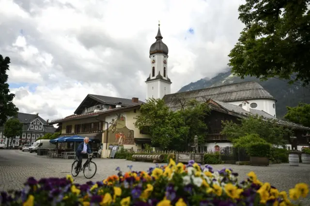 A local man rides through a square in the picturesque German town of Garmisch Partenkirchen