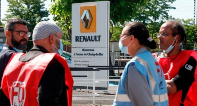 Employees of French carmaker Renault gather near one of its Paris sites to protest at job cuts