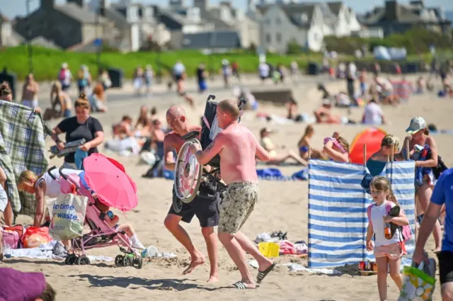 Members of the public enjoy the warm weather at South Troon beach on Sunday