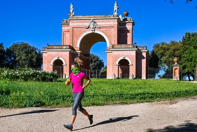 A woman jogs in the park of the Villa Doria Pamphili in Rome