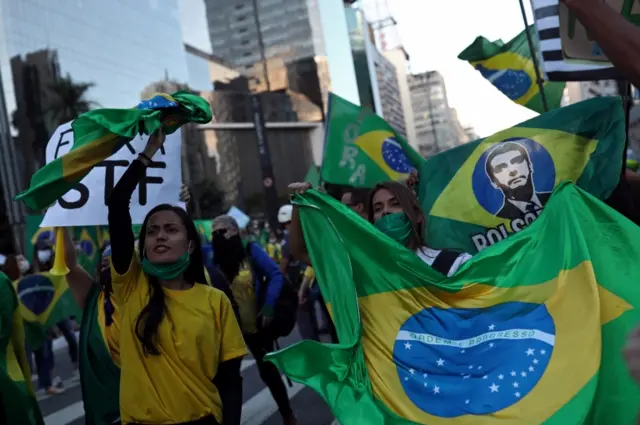 Protesters waving Brazilian flag