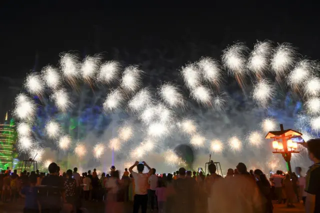 Visitors watch as fireworks explode, Hunan province