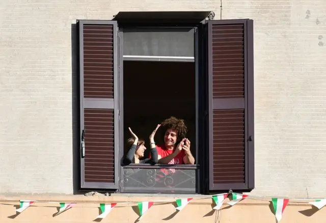 People applaud from their window during a flash-mob, May 3 Italy