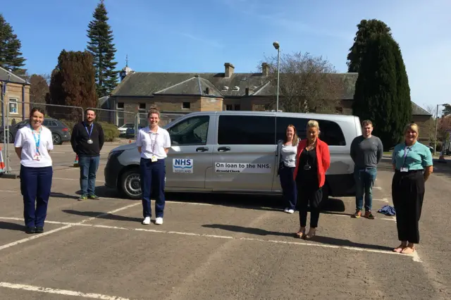 Staff with donated vehicle