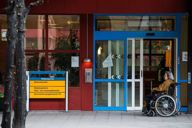 A woman sits outside her nursing home in Stockholm