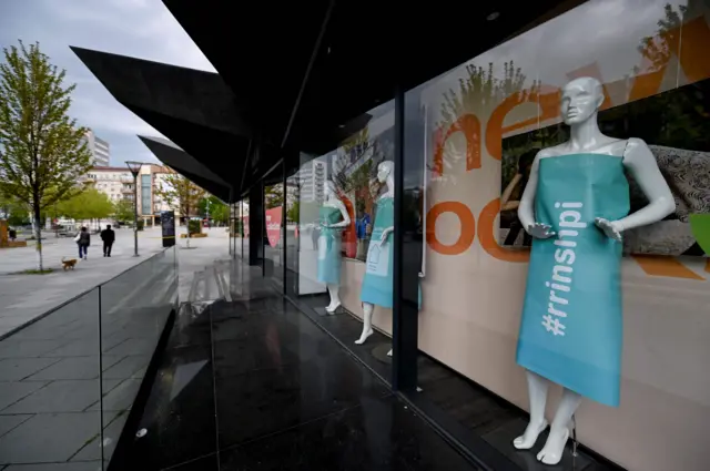 Dummies dressed in paper sheets bearing a message that reads "Stay at Home" are displayed in a closed boutique at the deserted square of Pristina on May 4, 2020, as the country is under lockdown to stop the spread of the Covid-19 pandemic.