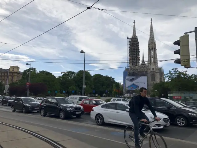 Street scene from Vienna on 4 May showing cyclist and traffic jam