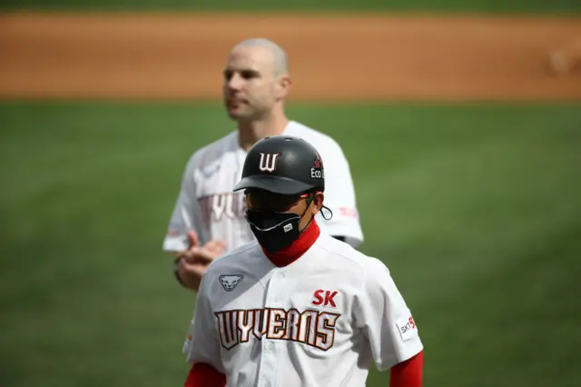 Wyverns first-base coach Cho Dong-hwa had to wear a mask during the game