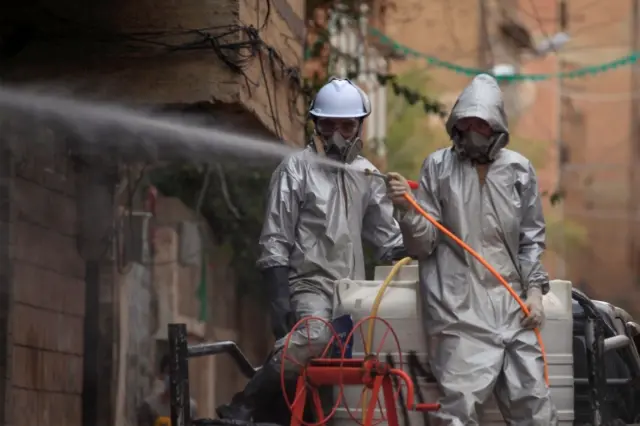 Workers disinfect an area of the rebel-held Yemeni capital, Sanaa (6 May 2020)